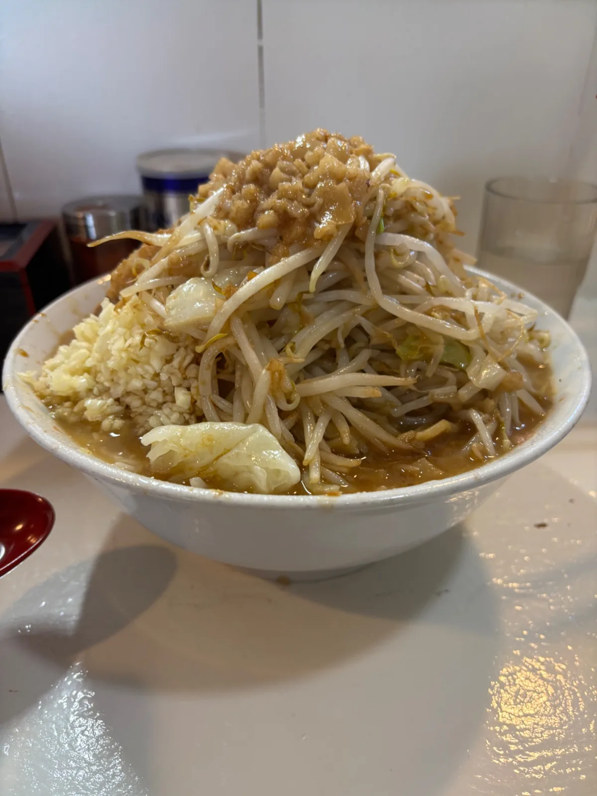 A bowl of Jiro-style ramen topped with vegetables and chashu pork